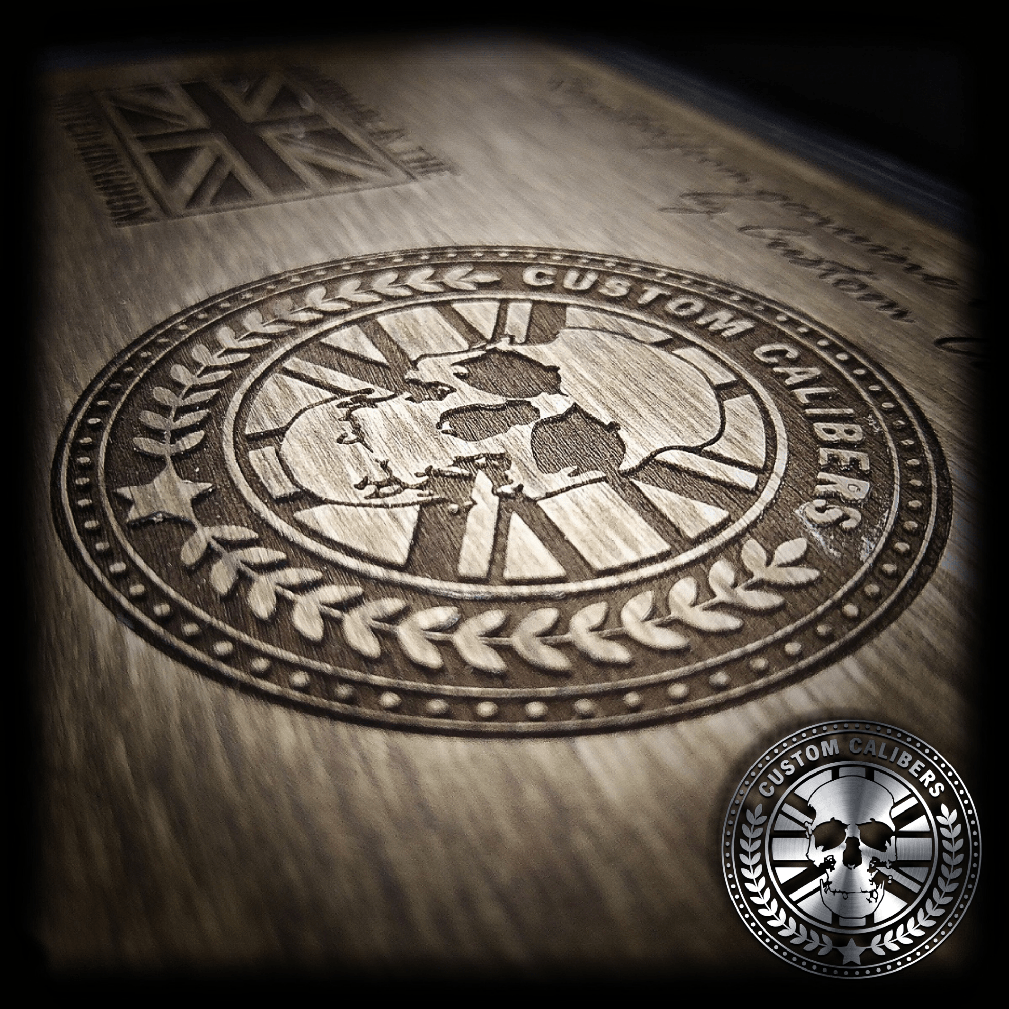 An image of Custom Calibers engraved into wood