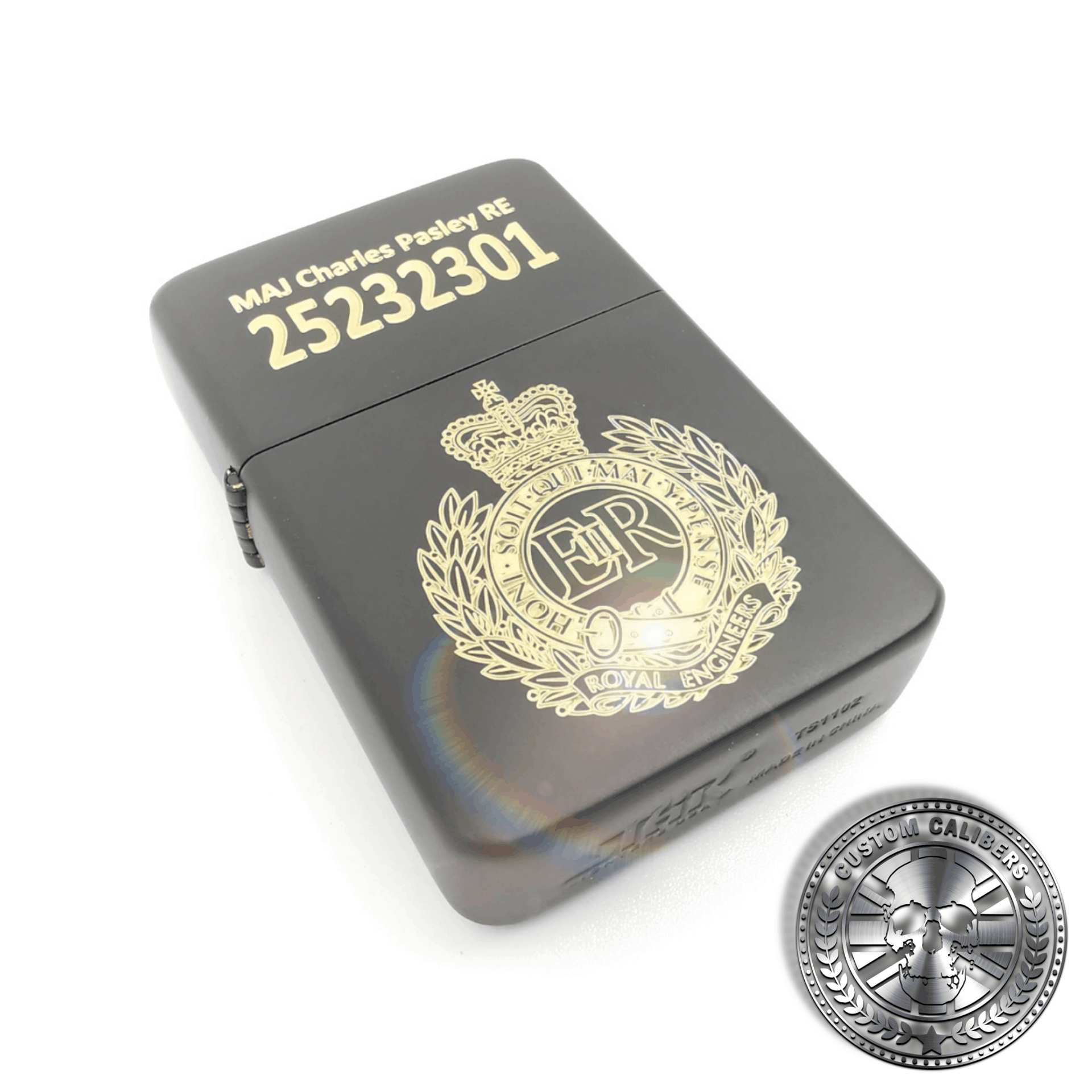 A full view shot of a matt black solid brass flip top lighter engraved with the royal engineers crest on the front with a name and military service number on the lid