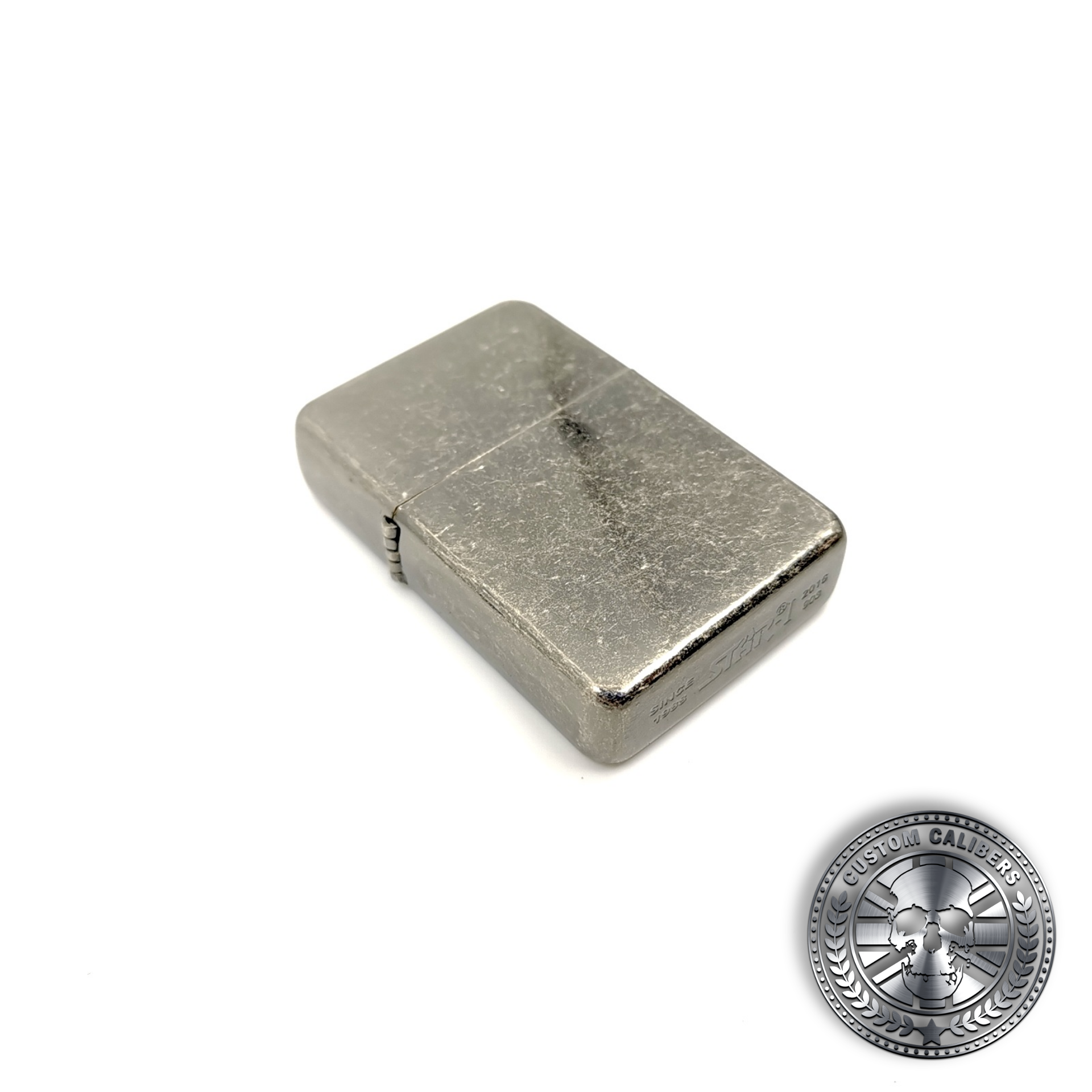 a great shot of an antique steel effect flip top oil lighter