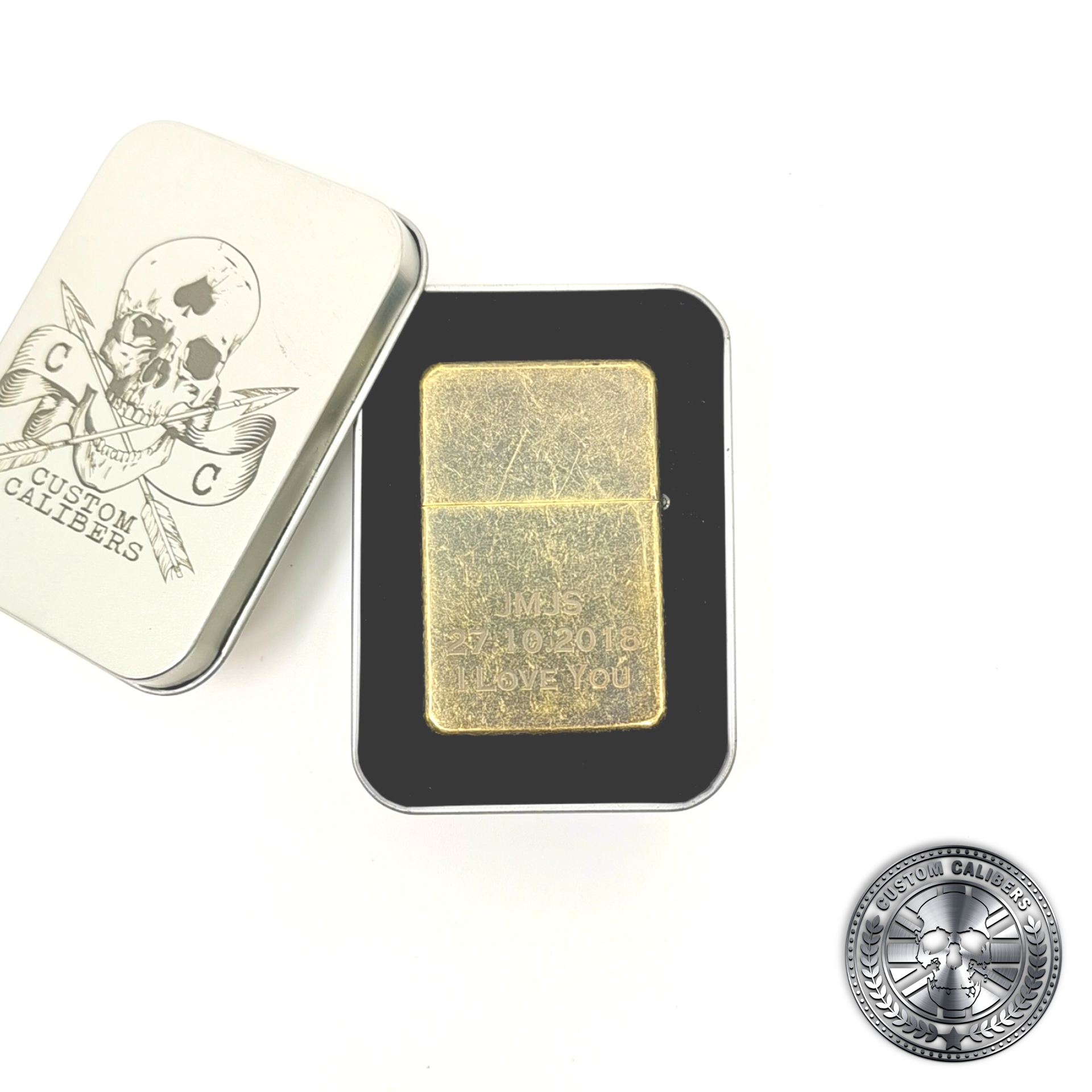 a photo of an antique brass effect flip top oil lighter in a tin gift box