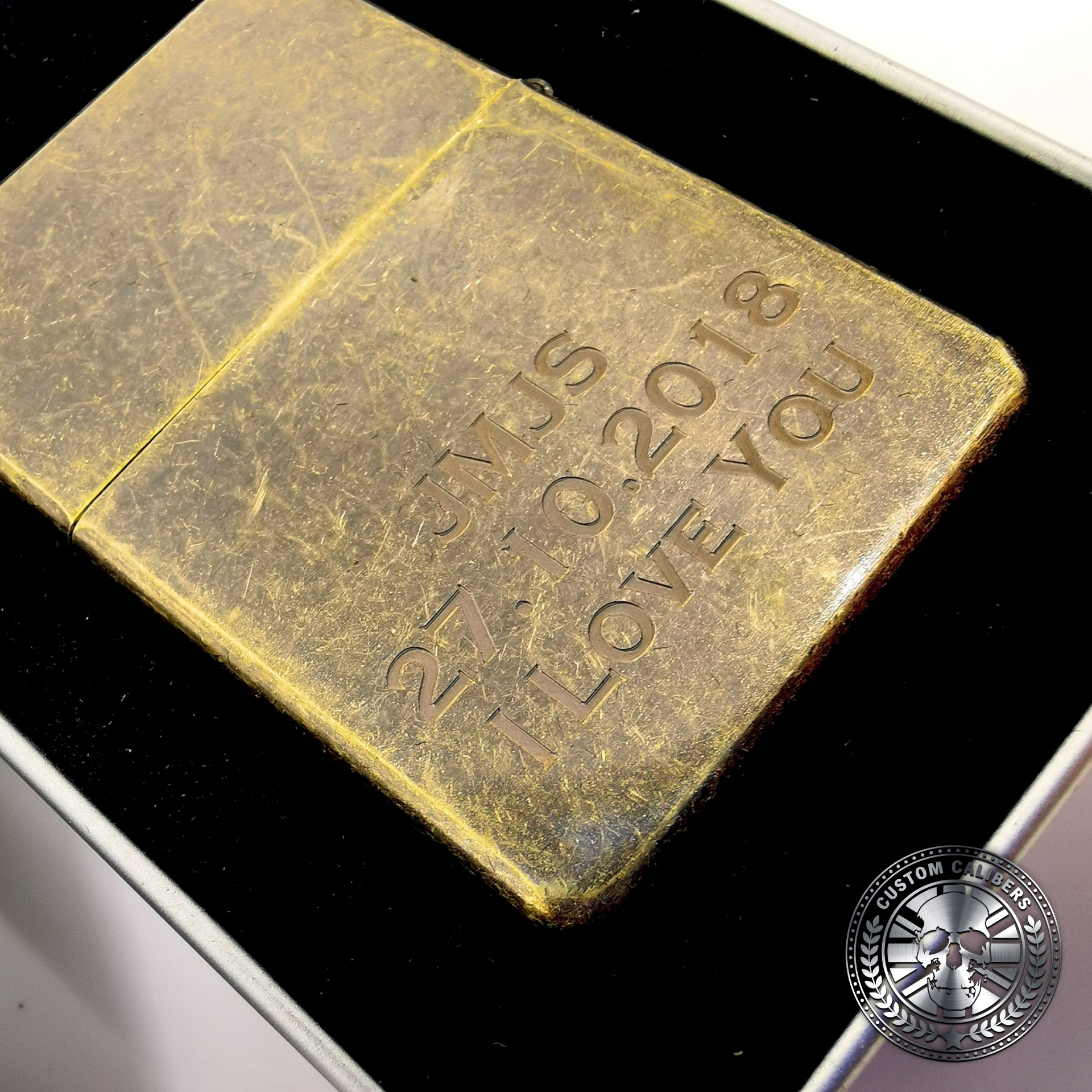 a photo of an antique brass effect flip top oil lighter inside a gift box