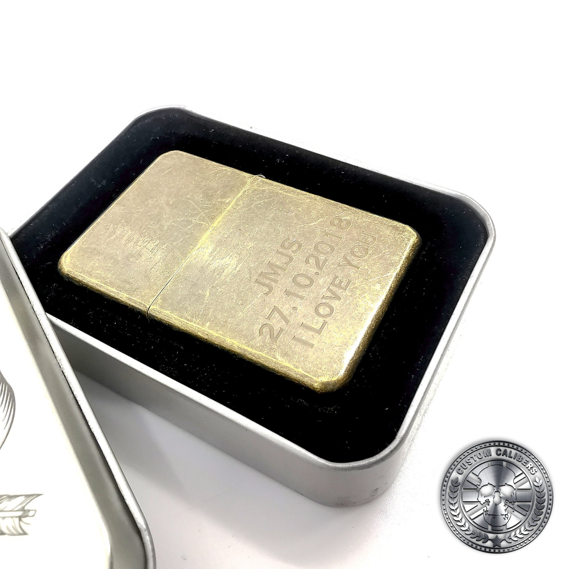 a photo of an antique brass effect flip top oil lighter in a tin gift box