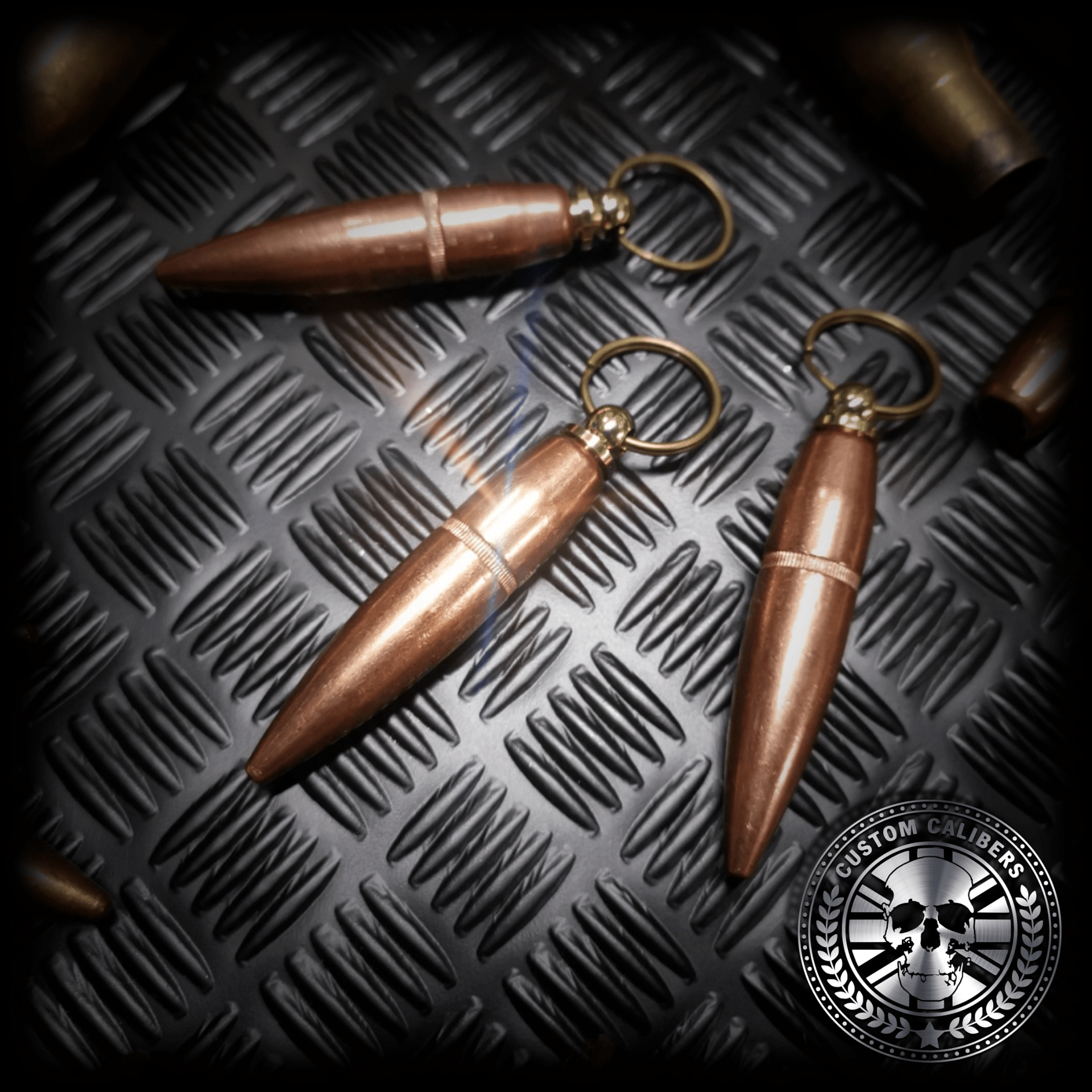 acloseupshotofthreecalbulletheadkeychains