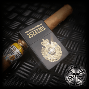A matt black lighter engraved with the royal engineers crest resting on a cuban cigar
