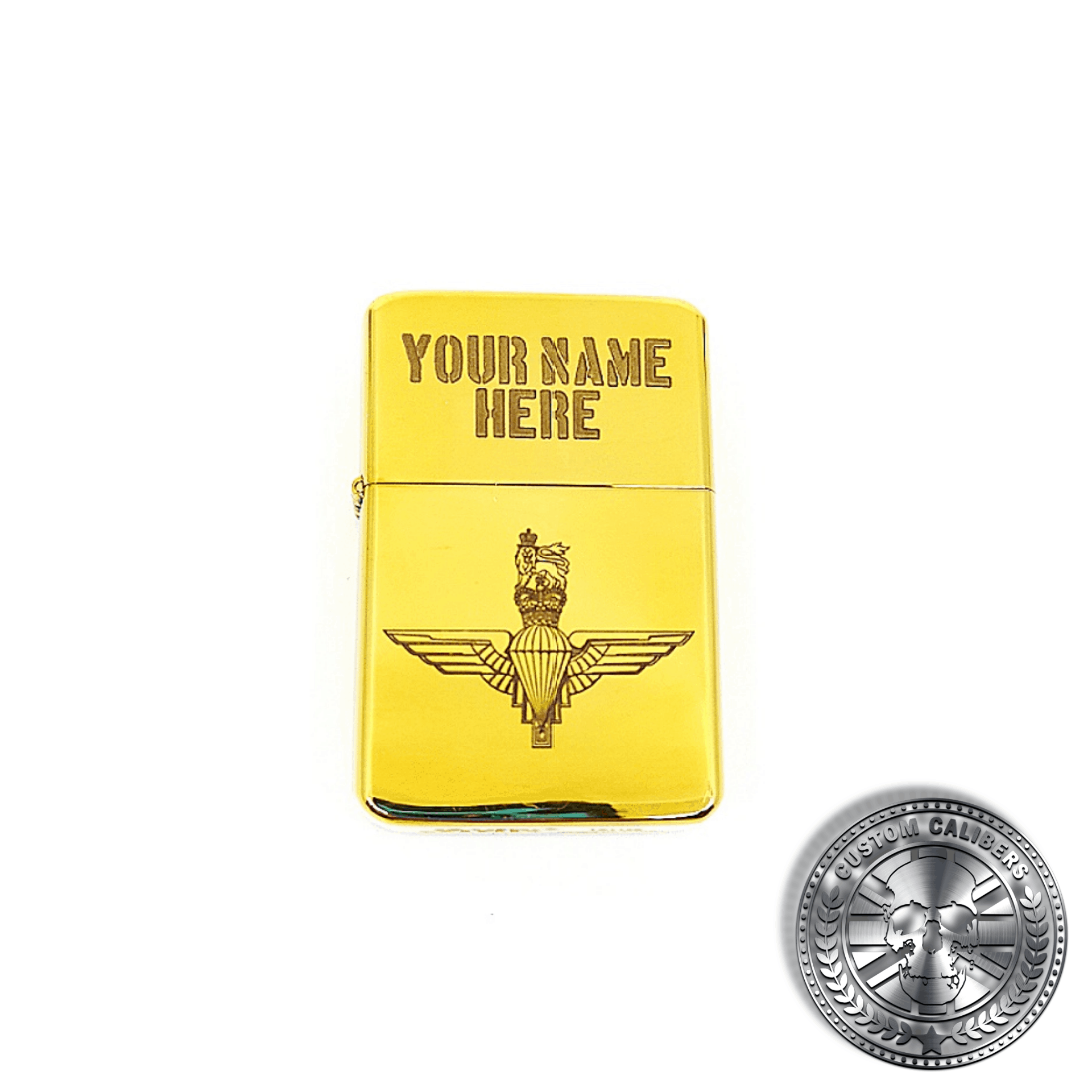 a full range shot of a polished solid brass flip top lighter engraved with the parachute regiments logo on the front