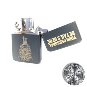 A close up shot of a matt black solid brass flip top lighter engraved with the royal marines crest on the front with a name and military service number on the lid which has been opened to show the inside of the lighter