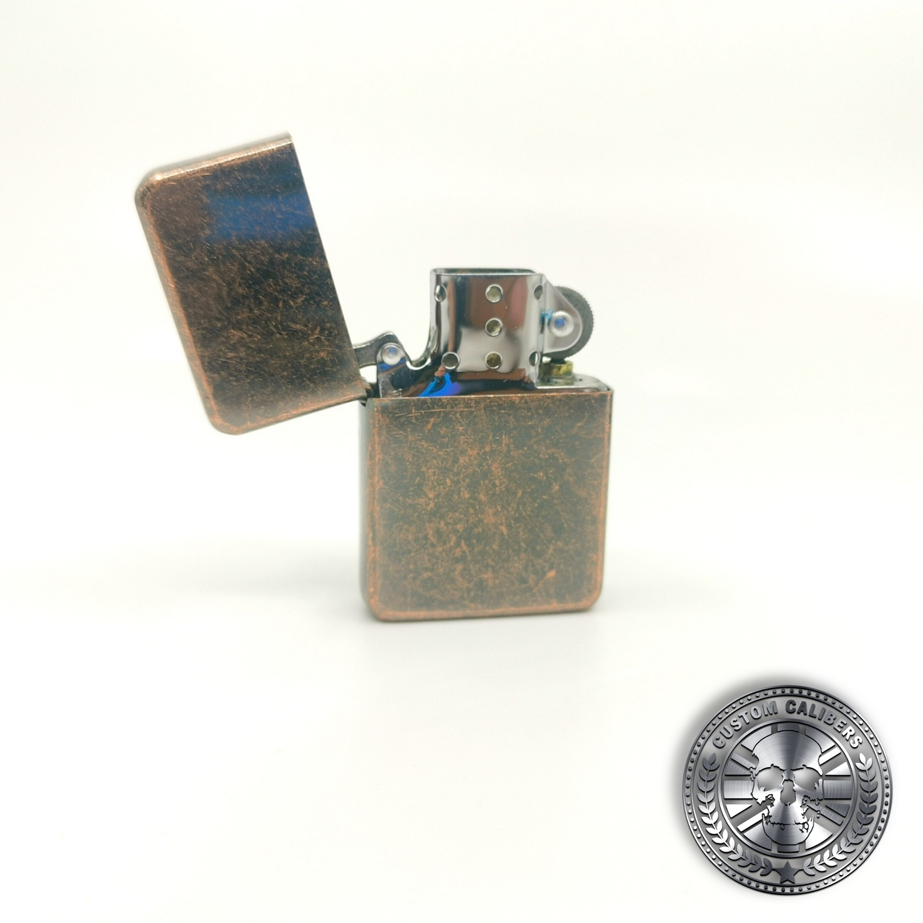a great shot of an antique copper effect flip top oil lighter