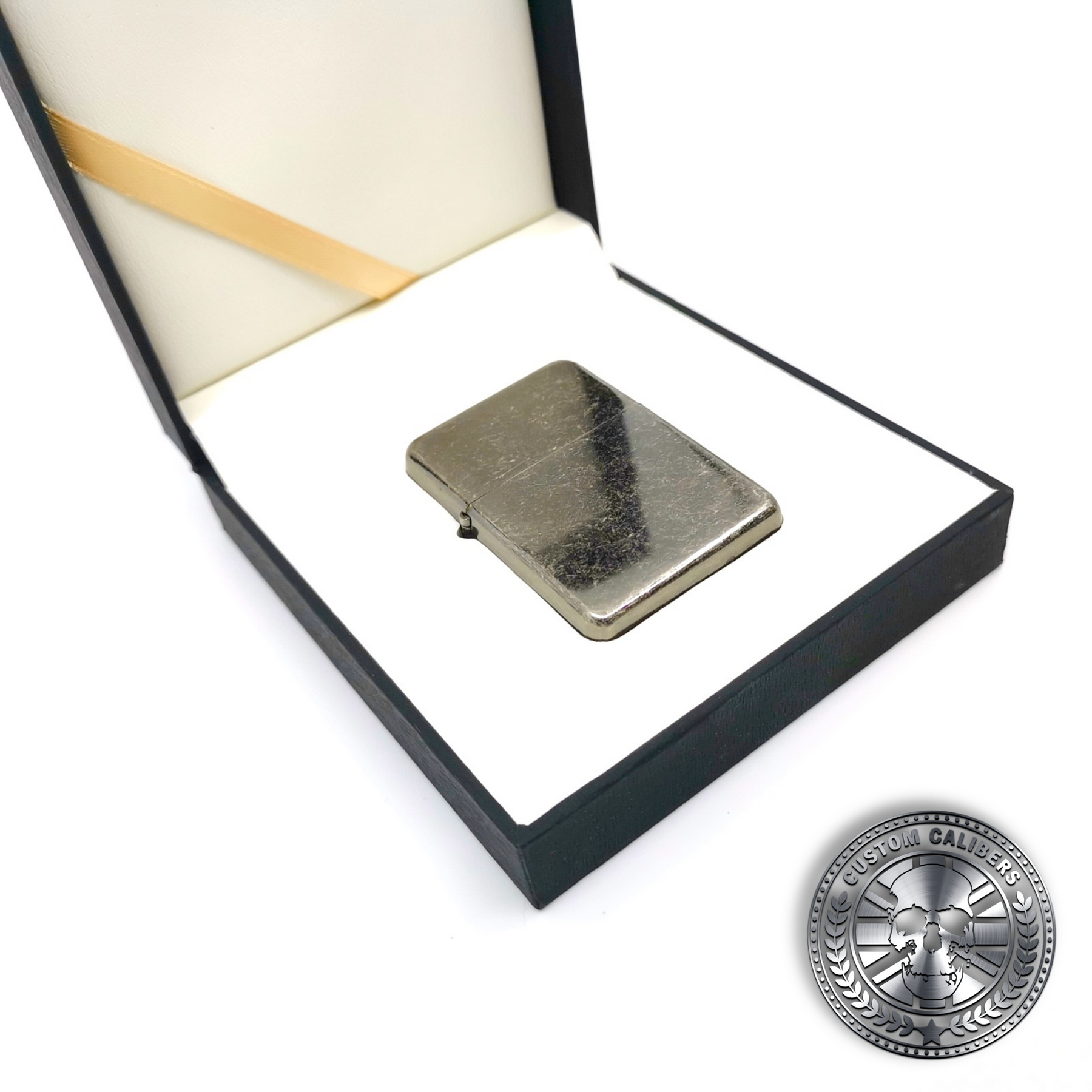 an antique steel effect flip top oil lighter inside a luxury gift box