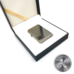 an antique steel effect flip top oil lighter inside a luxury gift box