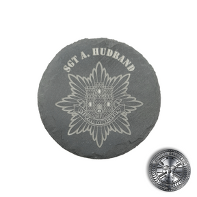 an engraved slate coaster with the royal anglian regiment crest