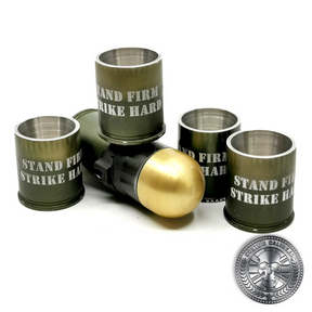 a quality photo of several 40mm GMg grenade shot glasses made from real once fired cases with engraved text