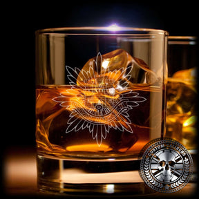 A glass of whiskey with ice and the royal anglian logo with the custom calibers logo on the bottom right